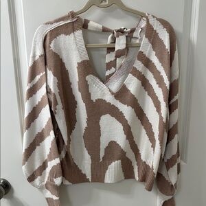 Brown and White V-Neck Sweater with Bold Pattern